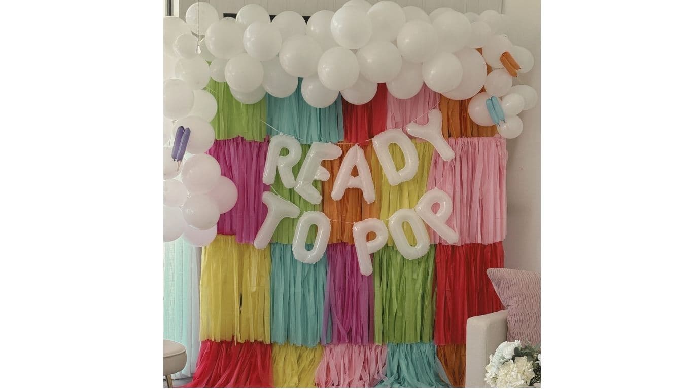 Ready to Pop baby shower backdrop with balloon garland