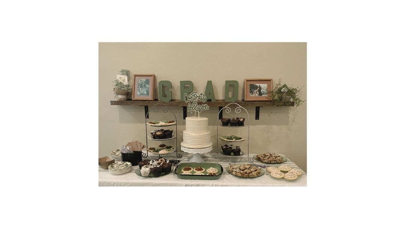 Graduation dessert table with GRAD sign styled by Elevated Creations